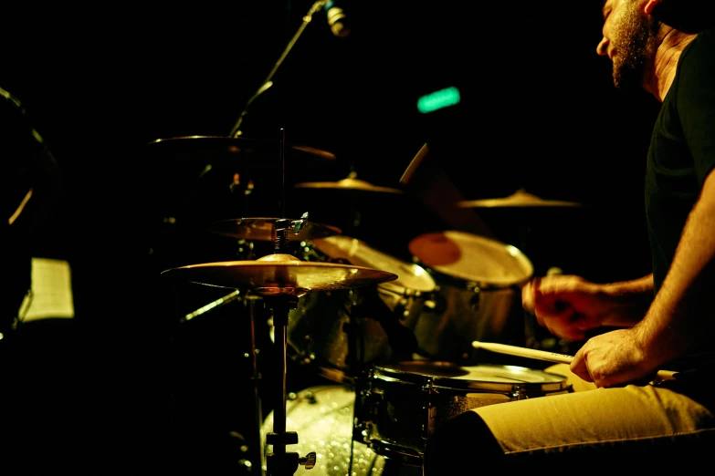 a man playing drums in a dark room, flickr, low detail, ilustration, lachlan bailey, panoramic