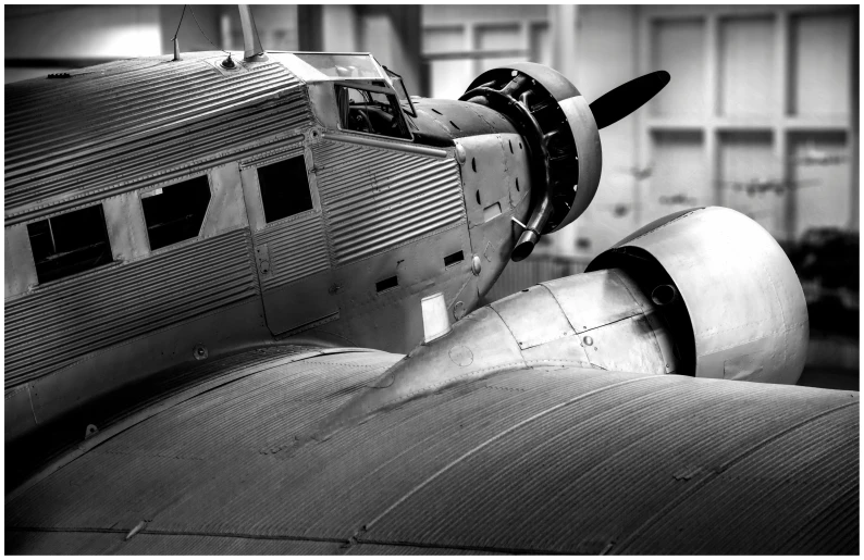 a black and white photo of an old airplane, a black and white photo, by Dave Melvin, pexels contest winner, photorealism, oversized enginee, deco, aluminum, instagram photo