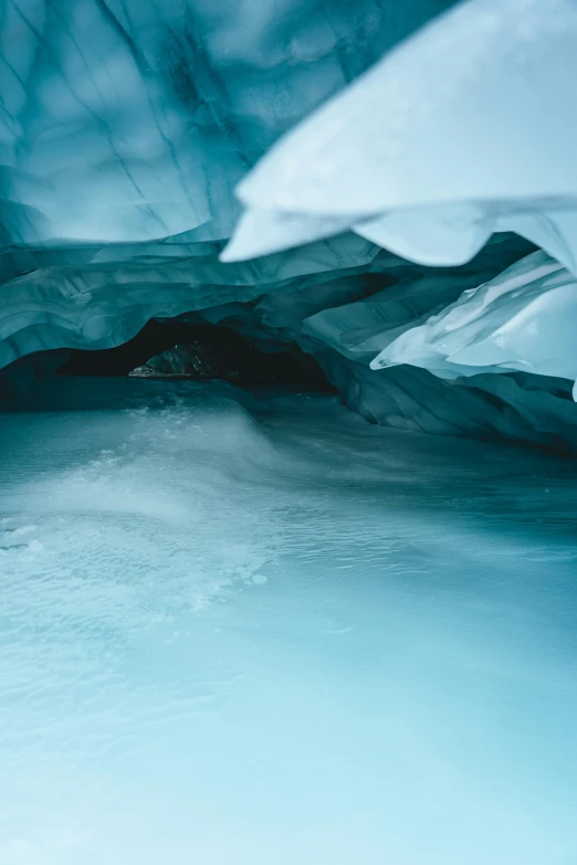 a view of the inside of an ice cave, unsplash contest winner, muted cold colors, blue liquid and snow, 4k”