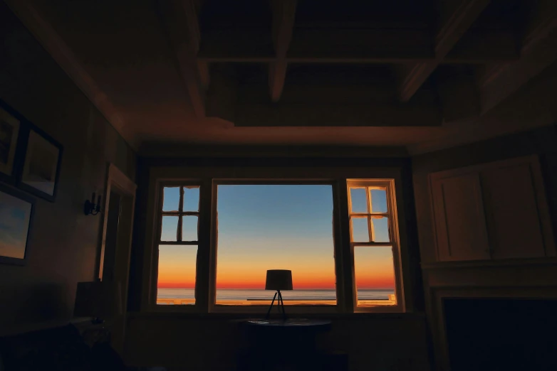 a chair that is sitting in front of a window, a picture, unsplash contest winner, sunset ligthing, bay window, room lighting, over the horizon