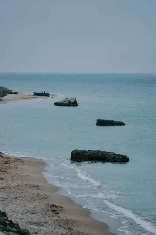 a couple of boats sitting on top of a sandy beach, inspired by Matthijs Maris, unsplash, mingei, stone colossus remains, dunkirk, portholes, chicago