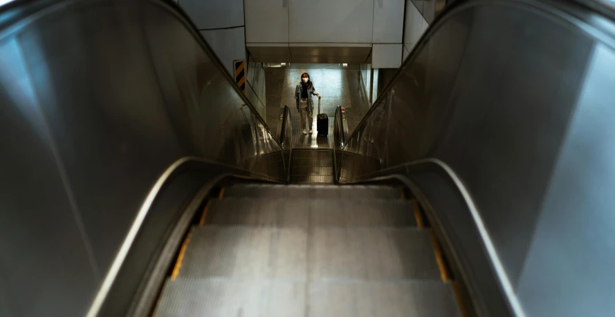 a person riding an escalator down an escalator, hyperrealism, sparsely populated, australian, taken with sony alpha 9, portrait of tall