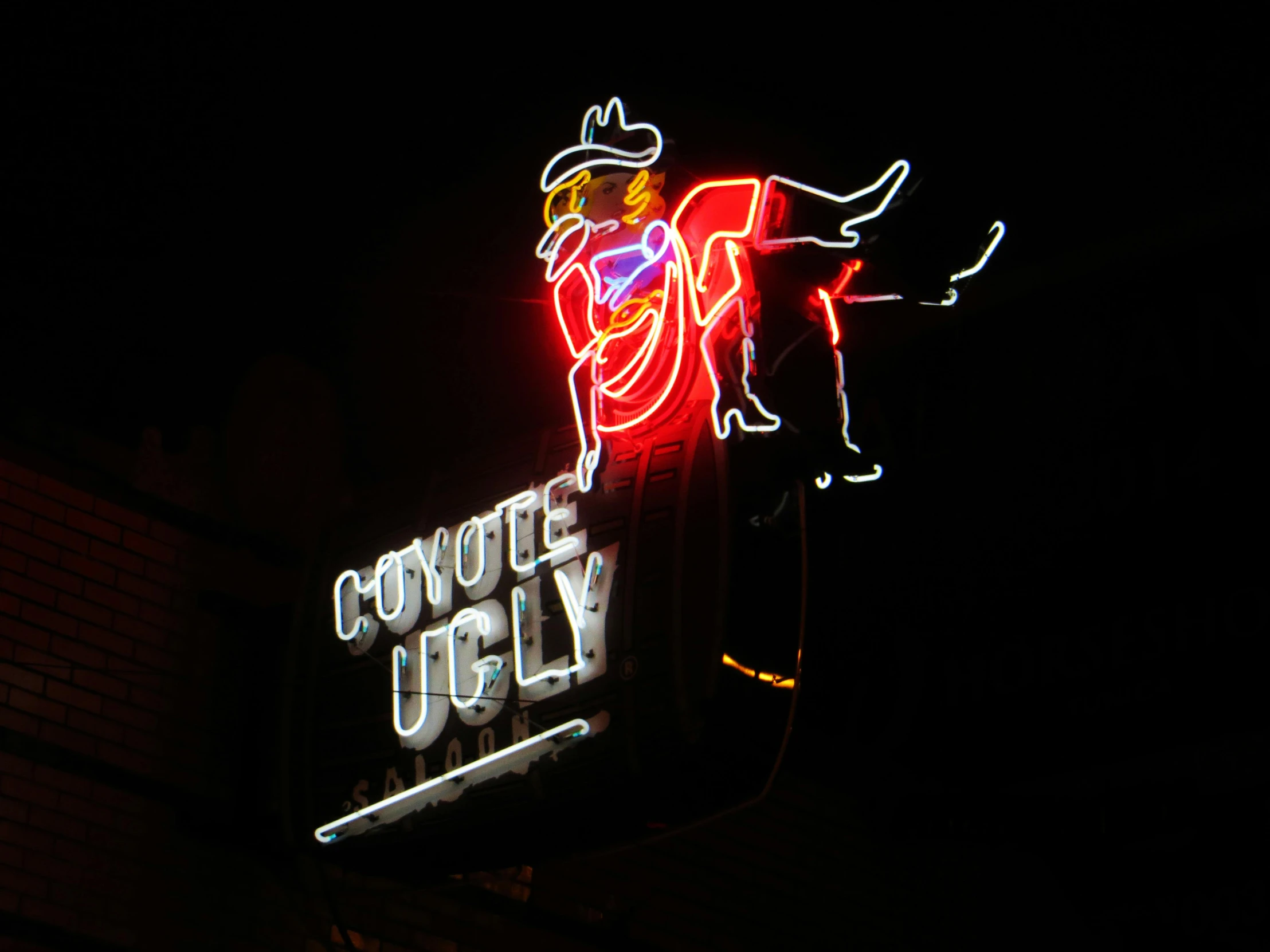 a neon sign on the side of a building, pexels, cowboy themed, early cuyler, light cone, lucky luke