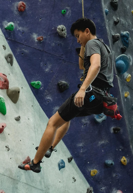 a man is climbing on a rock wall, happening, darren quach, central hub, model is wearing techtical vest, profile picture