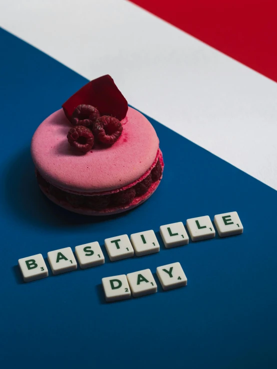 a pink macaron sitting on top of a blue and white table, an album cover, by Daniël Mijtens, trending on unsplash, french flag, battlefield, x - day, 🚿🗝📝