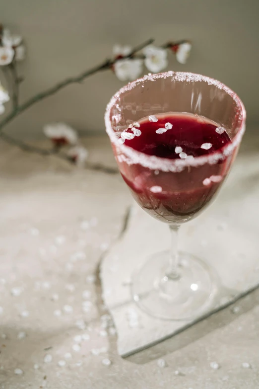 a glass of wine sitting on top of a table, slush, sparkling crystals, thumbnail, maroon