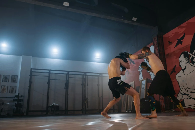 a couple of men standing on top of a cement floor, kickboxing, bounce lighting, demo scene, low quality photo