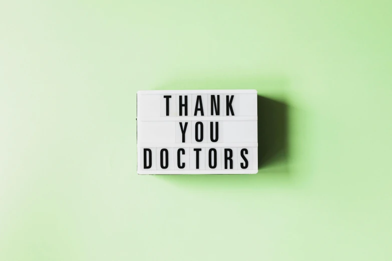 a sign that says thank you doctors on a green background, by Emma Andijewska, light box, on grey background, thumbnail, small in size