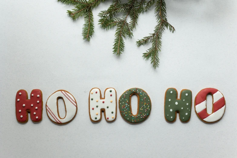 christmas cookies are arranged in the shape of the word ho ho ho, by Emma Andijewska, pexels, folk art, background image, sweet home, evergreen branches, 15081959 21121991 01012000 4k