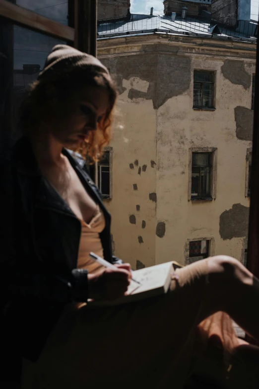 a woman sitting on a window sill writing, inspired by Nan Goldin, pexels contest winner, graffiti, alessio albi, promo image, notebook, anna nikonova aka newmilky