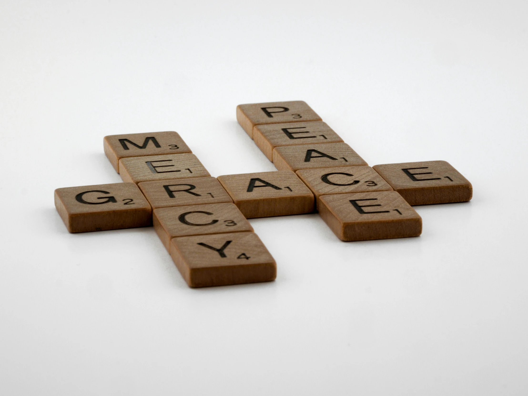 a cross made out of scrabbles on a white surface, by Grace Clements, unsplash, renaissance, mercy from overwatch, alternate album cover, peace, medium shot close up