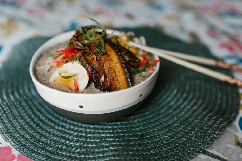 a close up of a bowl of food with chopsticks, a portrait, unsplash, mingei, background image, square, kanye west made out of congee, delightful surroundings