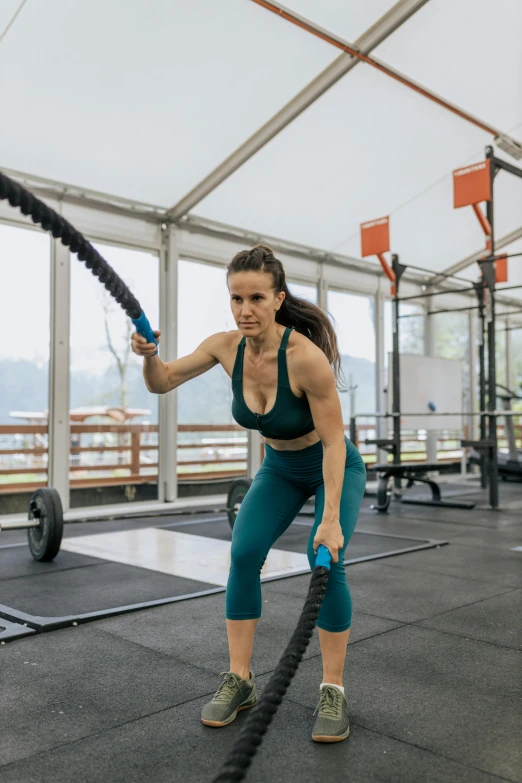 a woman holding a battle ropes in a gym, a portrait, by Emma Andijewska, pexels contest winner, nature outside, avatar image, thumbnail, hextech