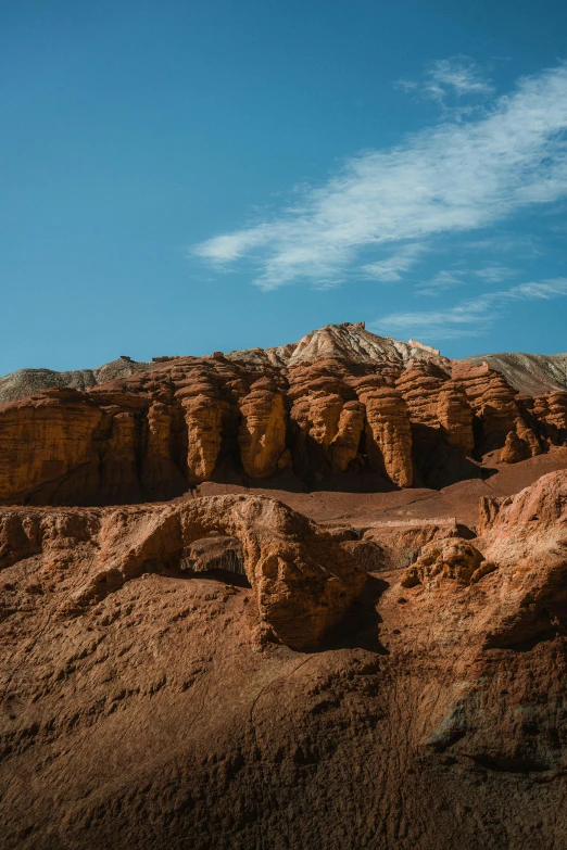 a large rock formation in the middle of a desert, paul barson, brown canyon background, andes, 2019 trending photo