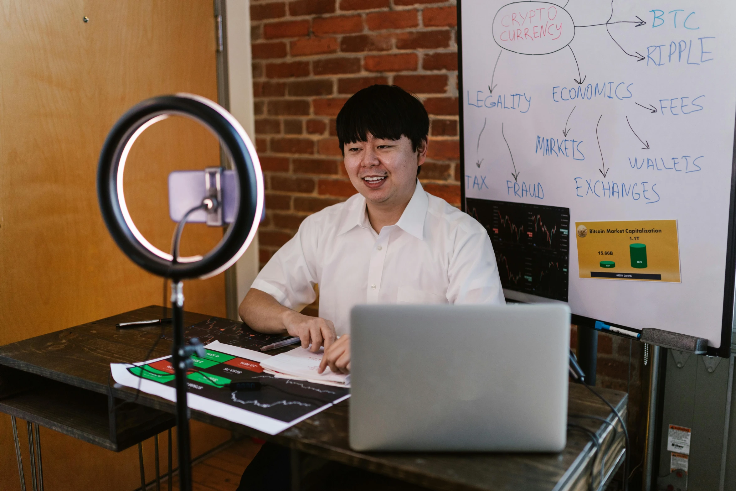 a man sitting at a desk in front of a laptop computer, by Jang Seung-eop, pexels contest winner, ring light, andy milonakis, on a canva, vp of marketing