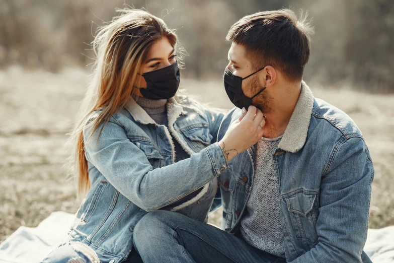 a man and a woman are sitting on a blanket, trending on pexels, dust mask, avatar image, kiss, lookbook