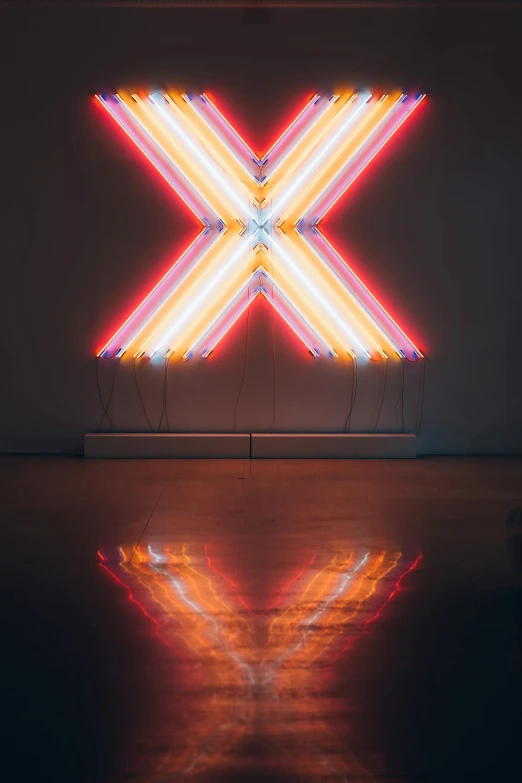 a neon sign sitting on top of a wooden floor, inspired by Bruce Nauman, pexels contest winner, minimalism, x logo, reflections ray, 2 5 6 x 2 5 6 pixels, museum art