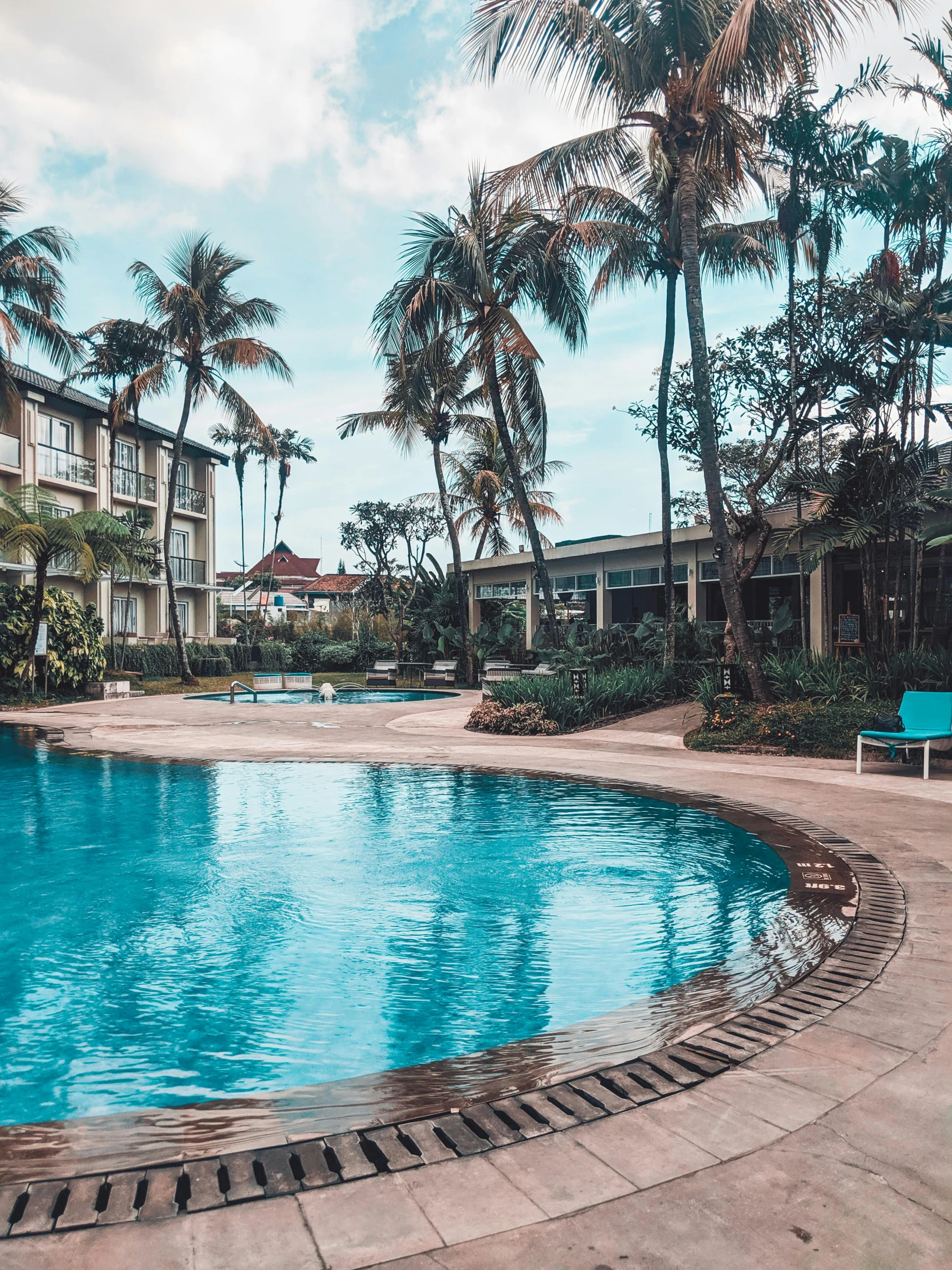 an empty swimming pool surrounded by palm trees, unsplash contest winner, south jakarta, 💋 💄 👠 👗, holiday resort, low quality photo