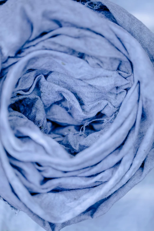 a close up of a blue blanket on a bed, made of silk paper, blue / grey background, scarf, ((blue))