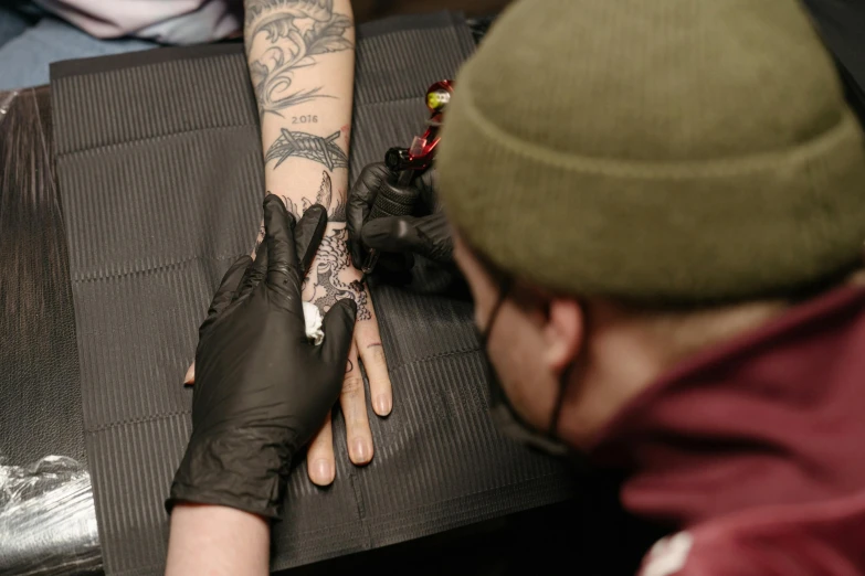 a man getting a tattoo on his arm, pexels contest winner, aaron horkey, hypervivid intense mcbess, an intricate