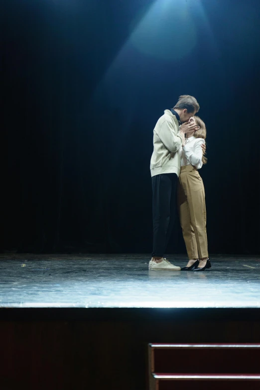a couple of people standing on top of a stage, a hologram, by Anita Malfatti, unsplash, kissing together cutely, film still of emma watson, ignant, intertwined full body view