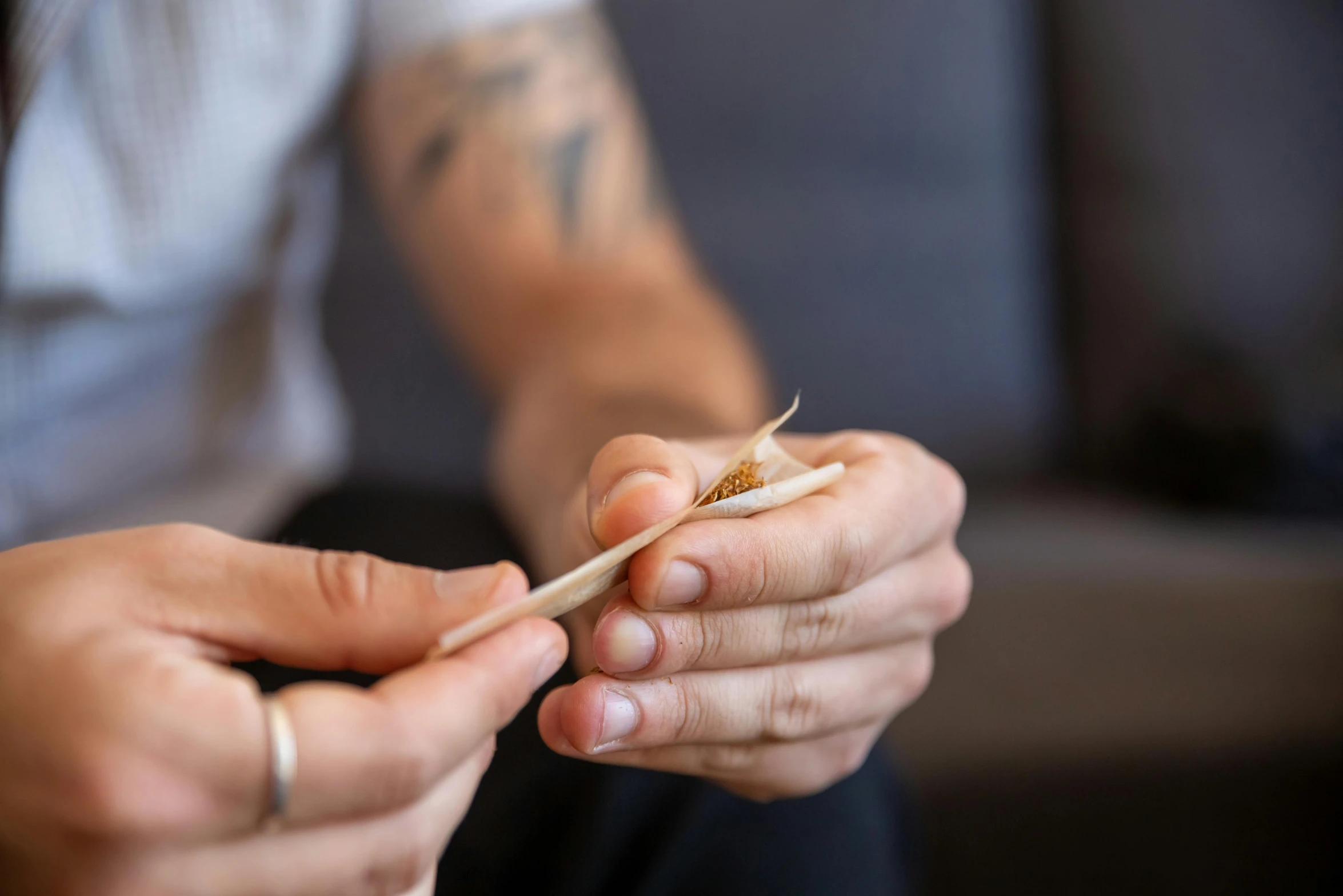 a close up of a person holding a pair of scissors, by Jessie Algie, smoking a joint, pointy shell, at home, pestle