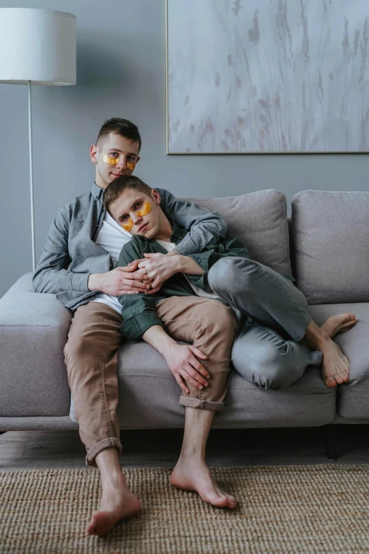 a man sitting on top of a couch next to a woman, by Sebastian Vrancx, pexels contest winner, two men hugging, twink, luka mivsek, sitting on a couch