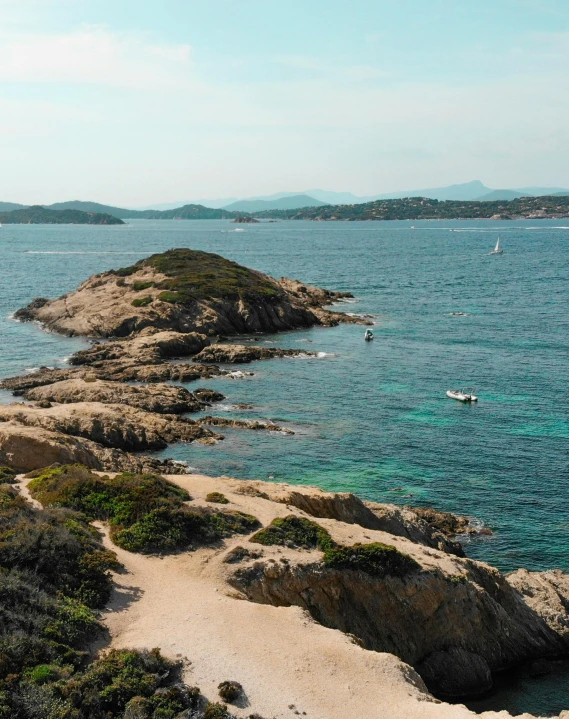 a sandy beach next to a body of water, pexels contest winner, les nabis, archipelago, in the distance is a rocky hill, thumbnail, traditional corsican