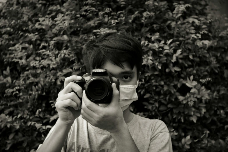 a person taking a picture with a camera, a black and white photo, by Alejandro Obregón, wearing facemask, professional picture, cute photo, professional photo-n 3