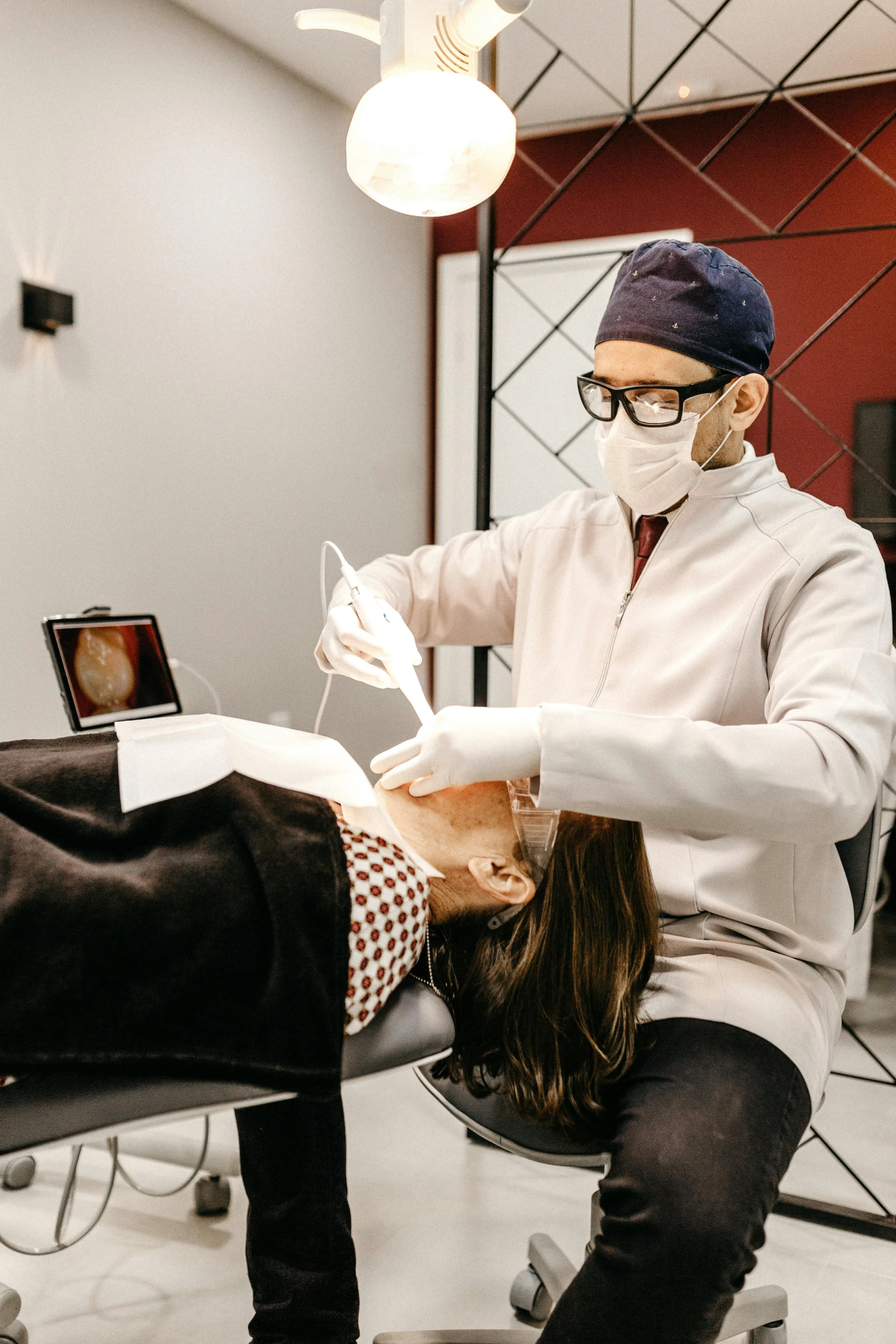 a woman getting her teeth examined by a dentist, a colorized photo, by Adam Marczyński, pexels contest winner, renaissance, a man wearing golden mask, with facial tattoo, as well as scratches, profile image