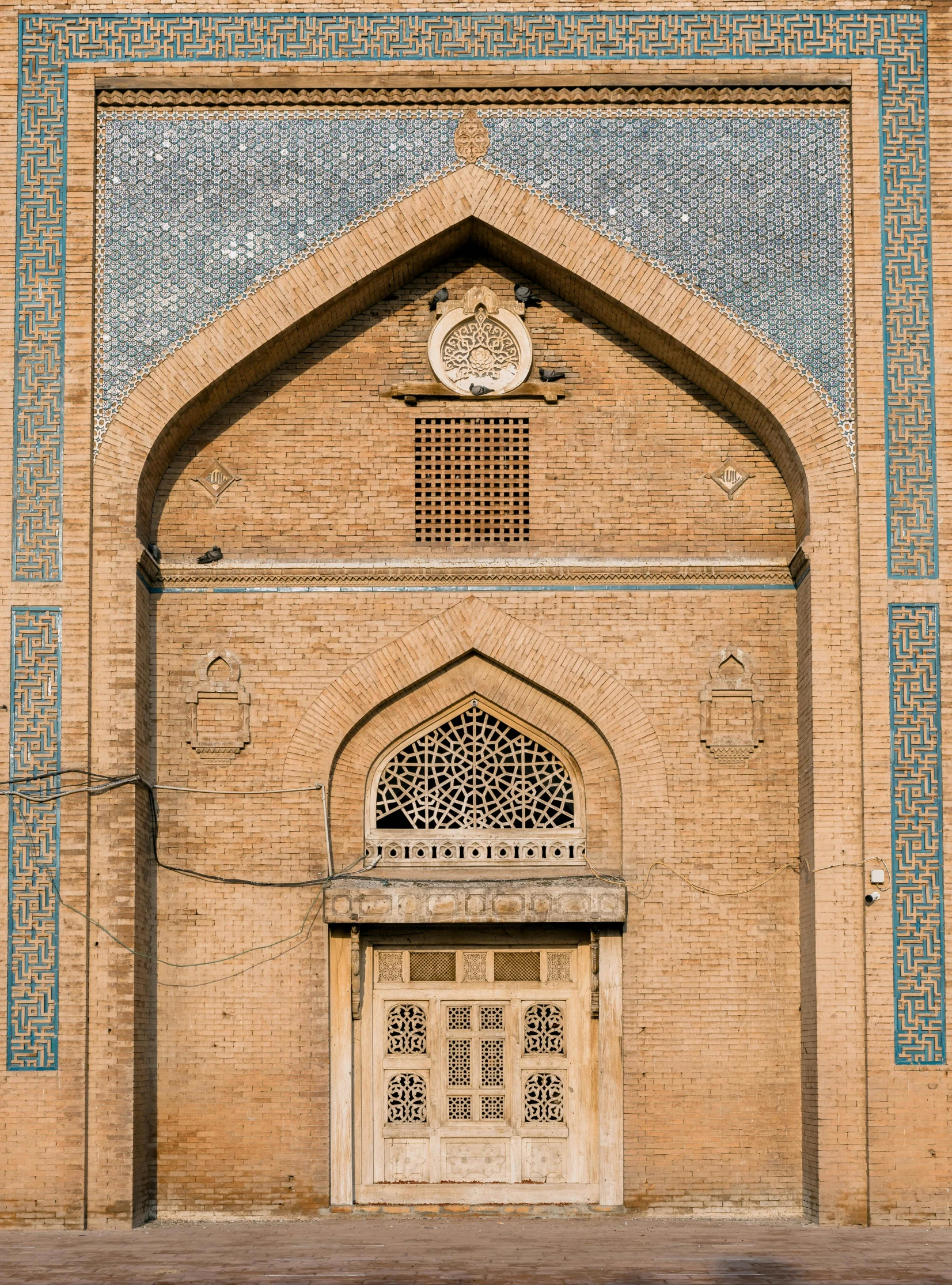 a close up of a building with a clock on it, an album cover, inspired by Kamāl ud-Dīn Behzād, trending on unsplash, qajar art, tall arched stone doorways, irregularly shaped mosaic tiles, sayem reza, wide high angle view