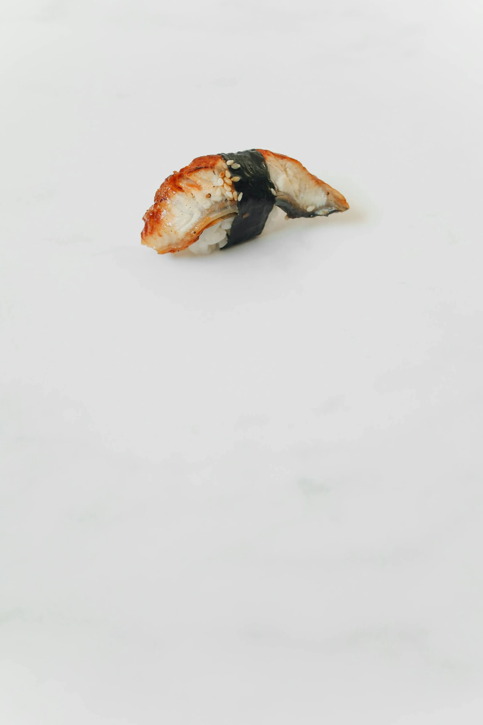 a piece of sushi sitting on top of a white plate, inspired by Nishida Shun'ei, sōsaku hanga, black on white background, torn, marbled, small jaw