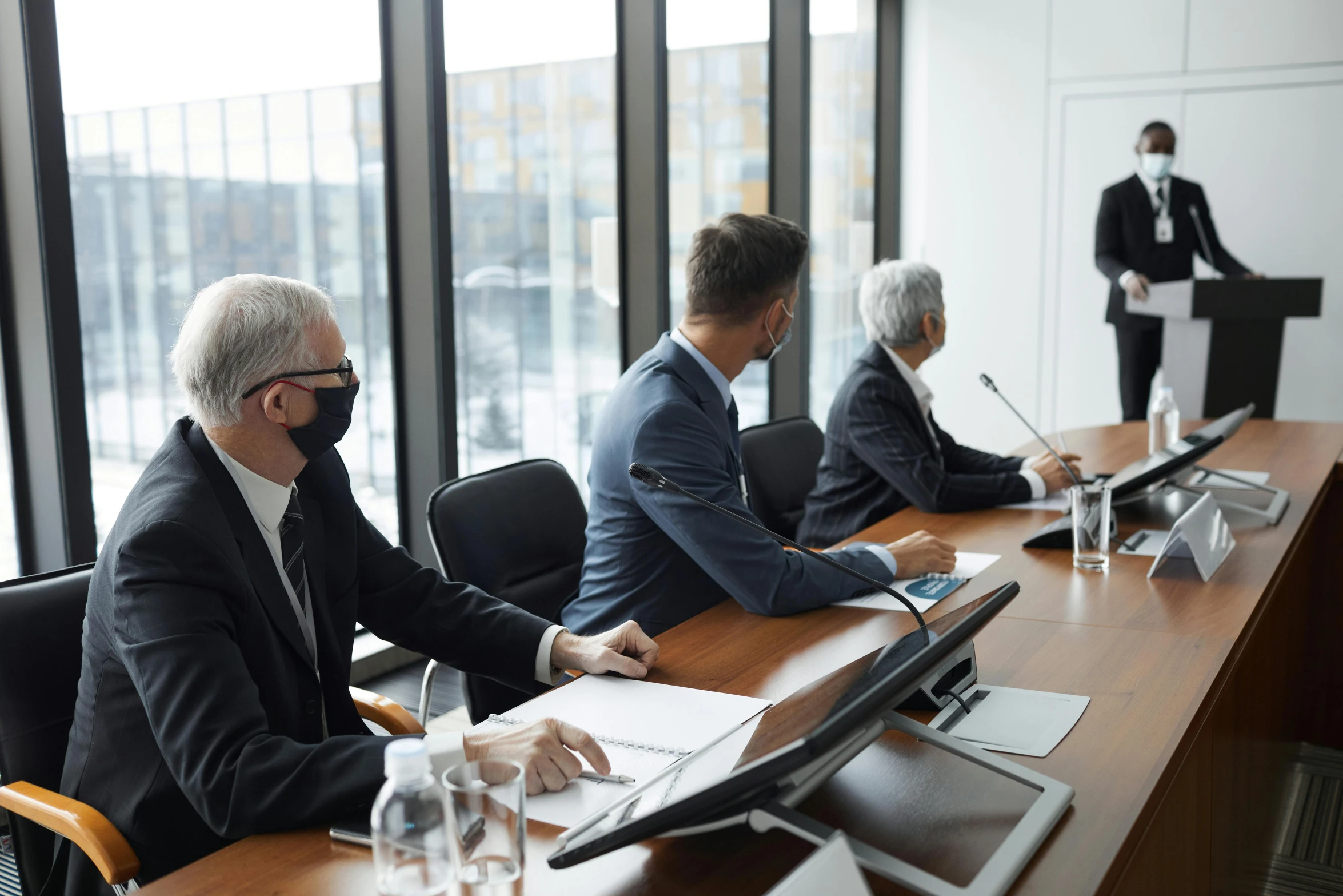 a group of people sitting around a conference table, profile image, conservatively dressed, presentation, thumbnail