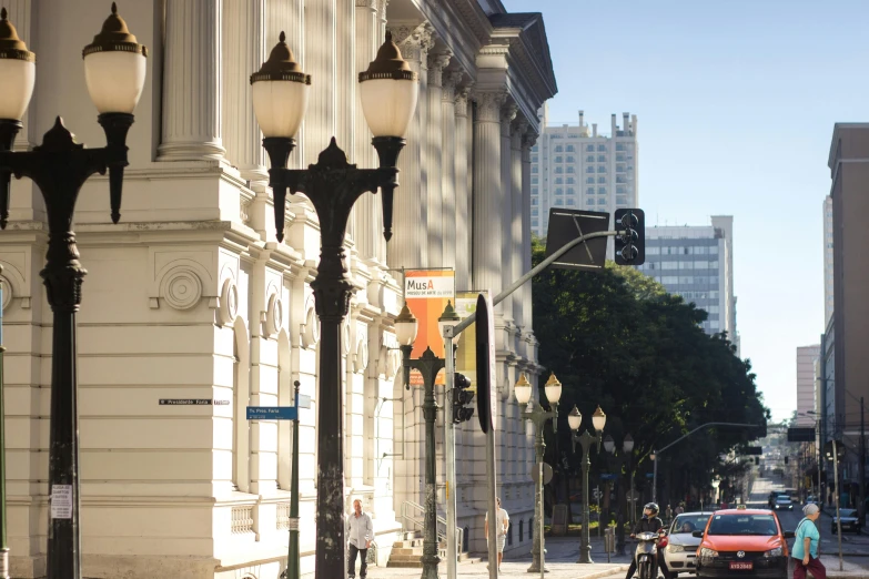 a street filled with lots of traffic next to tall buildings, a photo, neoclassicism, museum light, profile image, bay area