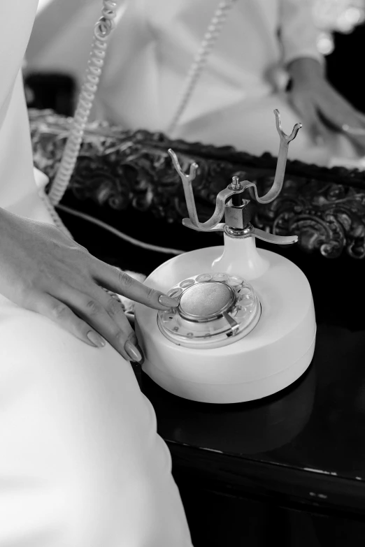 a black and white photo of a person on a phone, a black and white photo, by Joan Tuset, ring lighting, porcelain, wedding, plating