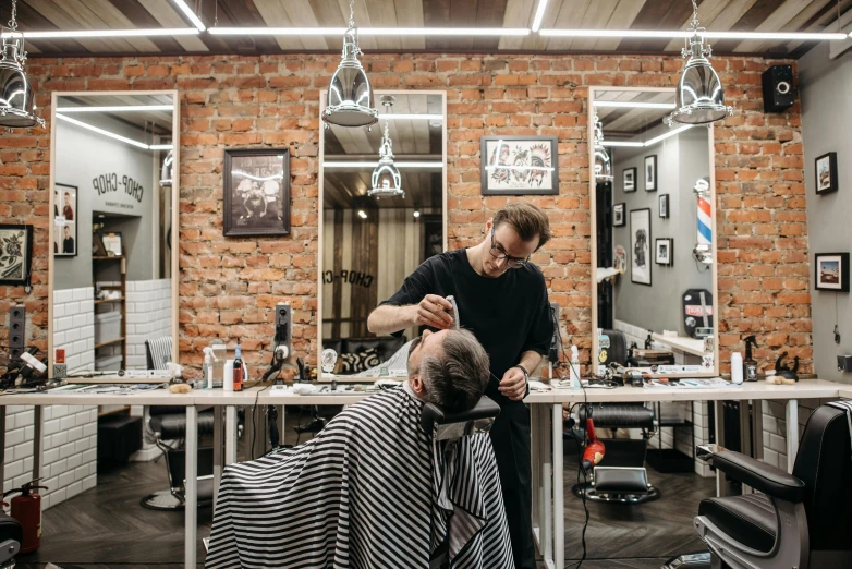 a man getting a haircut in a barber shop, by Samu Börtsök, shutterstock, arbeitsrat für kunst, alexey gurylev, instagram post, avatar image