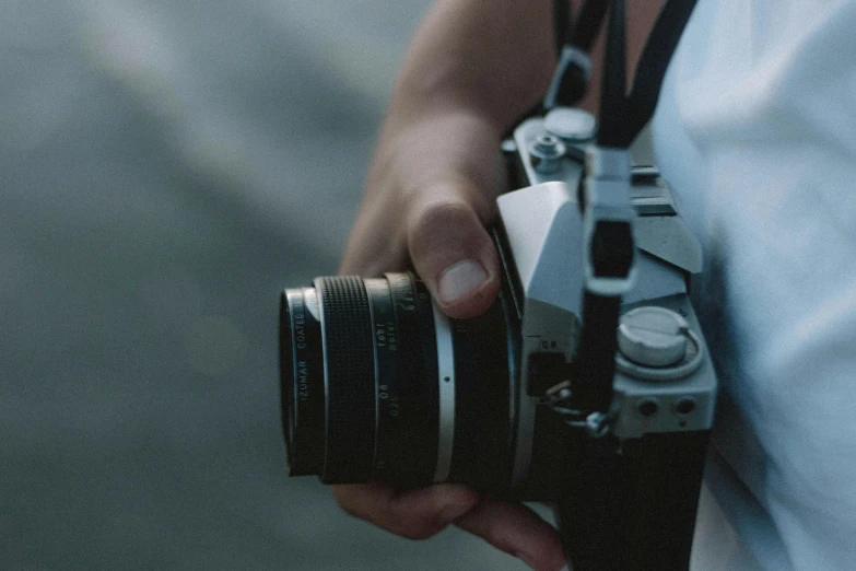 a close up of a person holding a camera, pexels contest winner, photorealism, 4x5 styled street photography, low quality photograph, antique photography, tourism photography