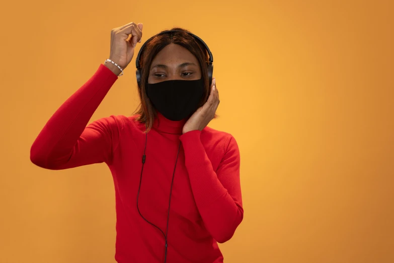 a woman wearing a black mask covering her face, an album cover, trending on pexels, afrofuturism, wearing a red turtleneck sweater, headphones dj rave, thumbnail, studio shot