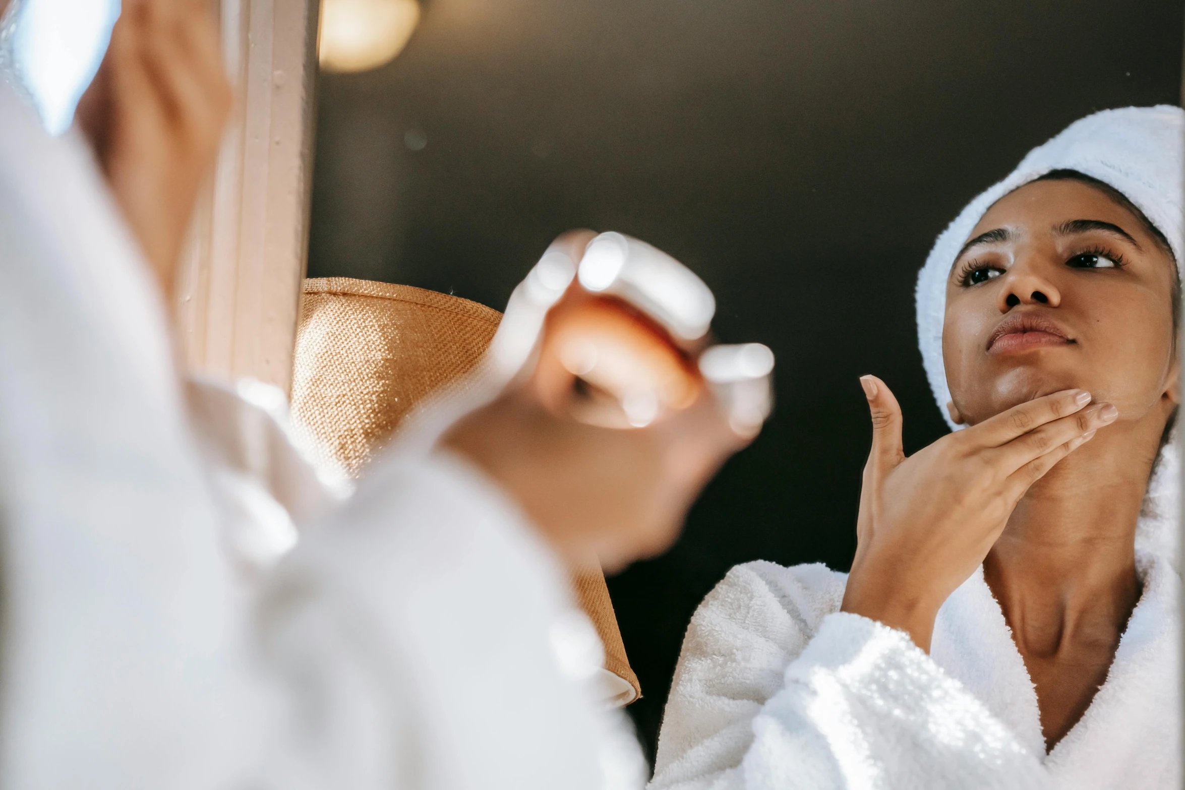 a woman is shaving her face in front of a mirror, trending on pexels, dressed in white robes, offering the viewer a pill, manuka, having a good time