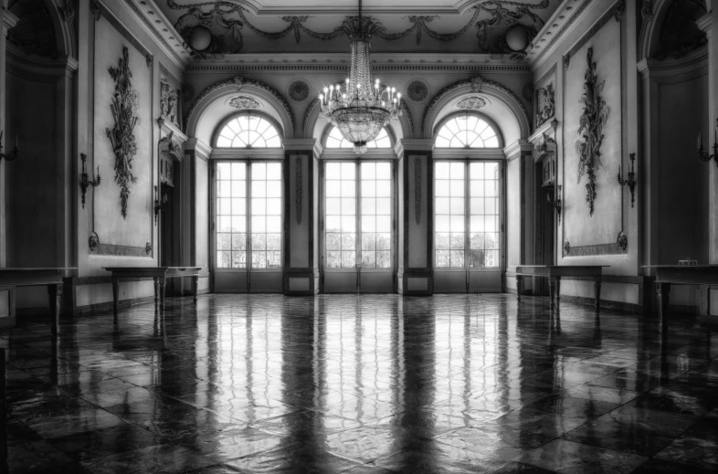 a black and white photo of a room with a chandelier, inspired by Emilio Grau Sala, unsplash contest winner, baroque, vast empty hall, large glass windows, tiled room squared waterway, palace dance