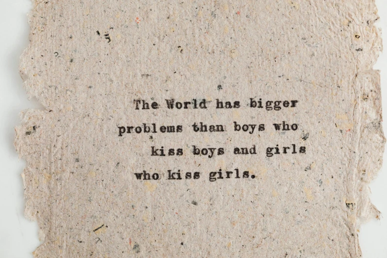 a piece of paper with the words the world has bigger problems than boys who kiss boys and girls who kiss girls, tumblr, androgynous, on old paper, big and small, very small lips