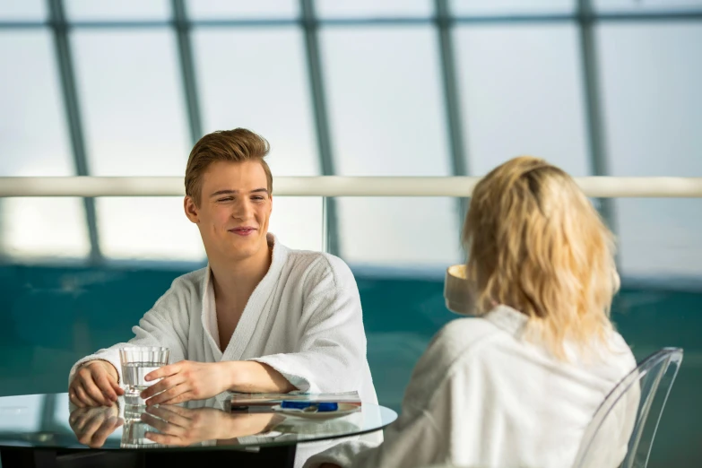 a couple of people that are sitting at a table, aquasixio, spa, lachlan bailey, teenage boy