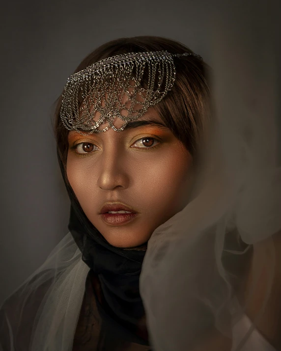 a close up of a woman wearing a veil, a colorized photo, inspired by irakli nadar, unsplash contest winner, intricate chrome headdress, androgynous person, south east asian with round face, portrait lighting