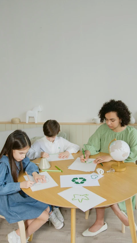 a group of children sitting around a wooden table, on a white table, recycled, thumbnail, #green