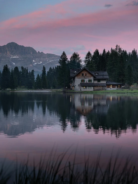 a house sitting on top of a lake next to a forest, a detailed matte painting, pexels contest winner, renaissance, evening at dusk, dolomites, at gentle dawn pink light, muted colors. ue 5