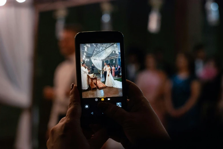 a person taking a picture with a cell phone, a picture, by Matt Cavotta, pexels contest winner, peasant wedding at midnight, instagram story, holding it out to the camera, slide show