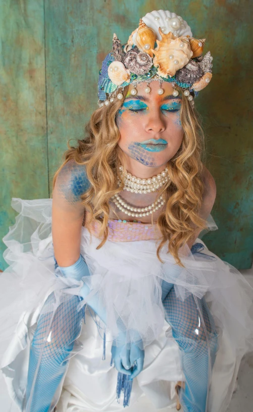 a woman in a white dress is posing for a picture, a portrait, inspired by Andrea del Verrocchio, deep sea themed, pose 4 of 1 6, light blue skin, posing in leotard and tiara