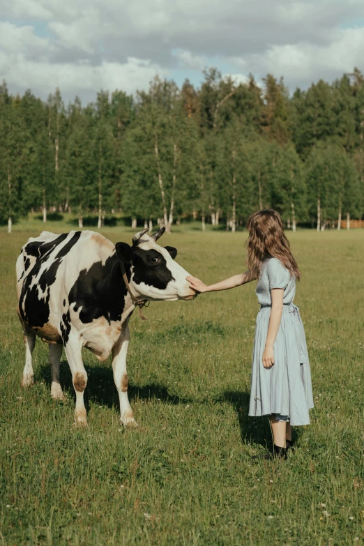 a woman standing in a field petting a cow, pexels contest winner, renaissance, greta thunberg, top milk brands, profile image, russian girlfriend