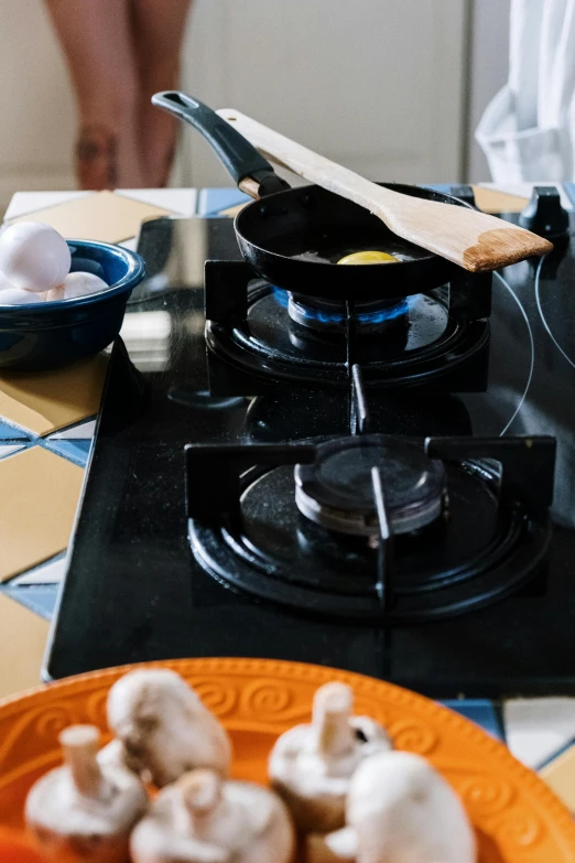 a close up of a plate of food on a stove, by Jan Tengnagel, square, eggs, near kitchen stove, mediterranean