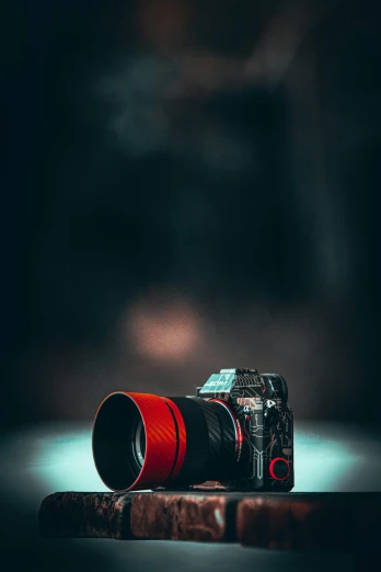 a camera sitting on top of a book, it has a red and black paint, rayonism light effects and bokeh, sony lens, full body in camera